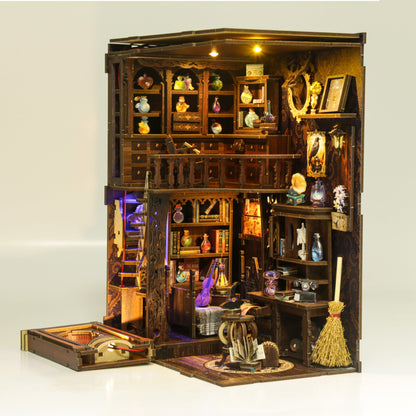 Miniature model of a bookshelf with various items inside
